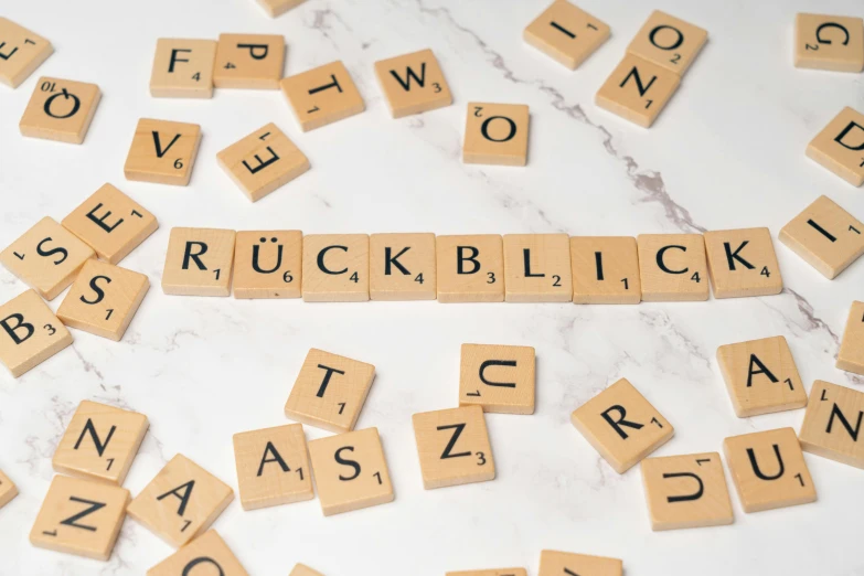 scrabble tiles spelling the words rock, brick and love