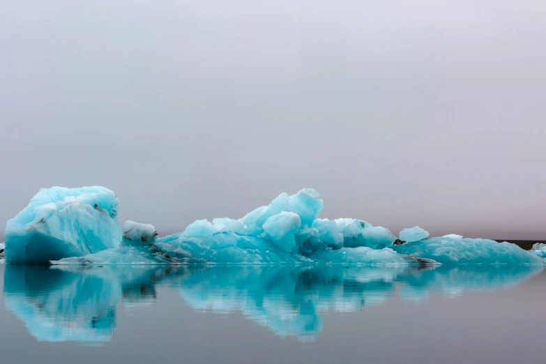 some ice floes float across a lake filled with water