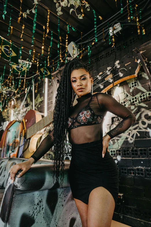 a woman in lingerie posing in front of a mural