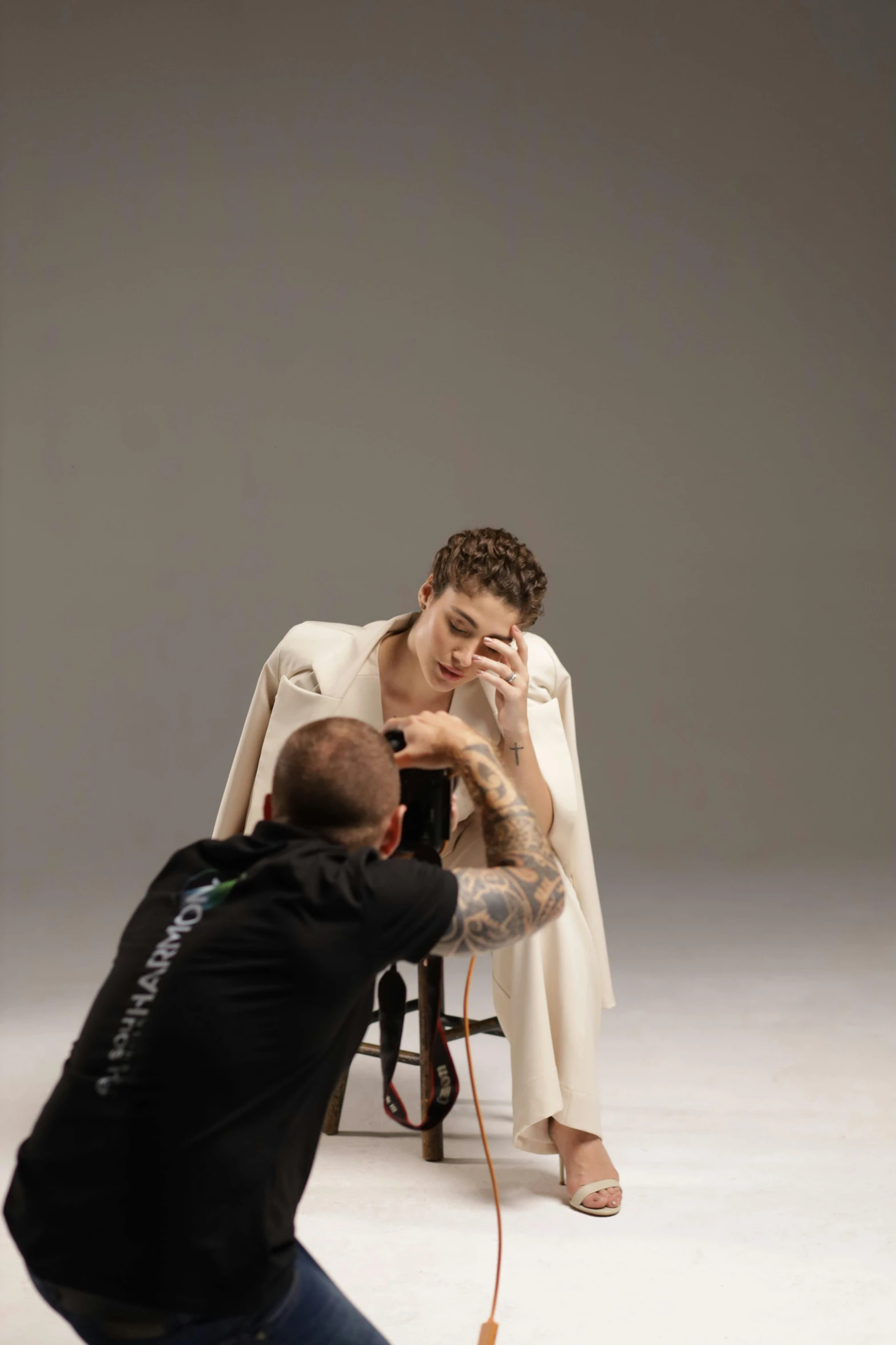 a woman sitting on top of a chair while she takes a picture