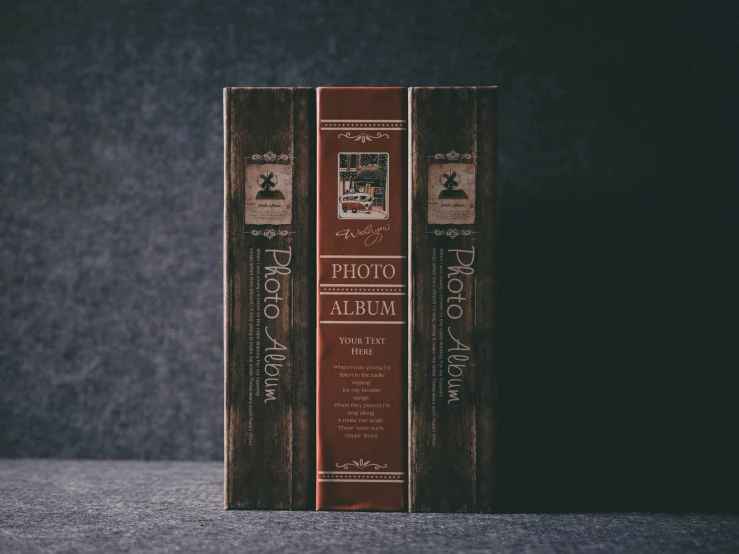 two vintage books sitting on top of a white surface