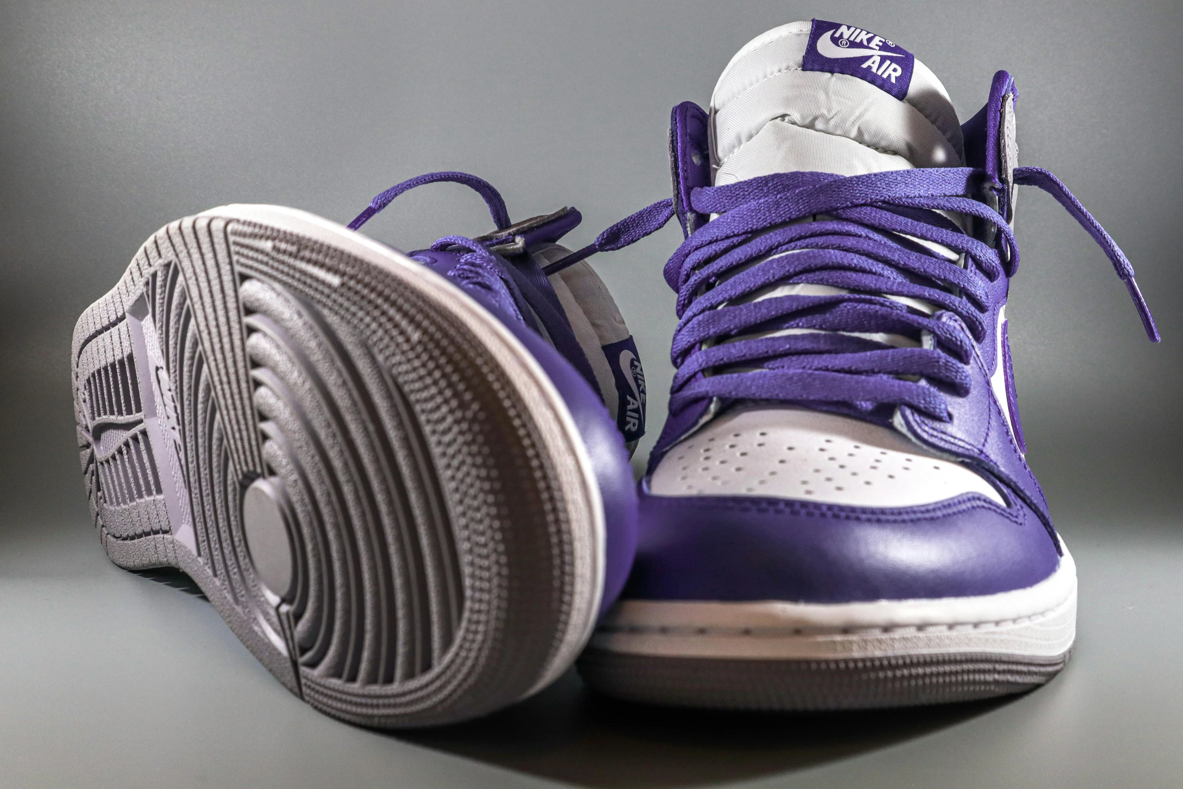 the purple sneakers are positioned on the table