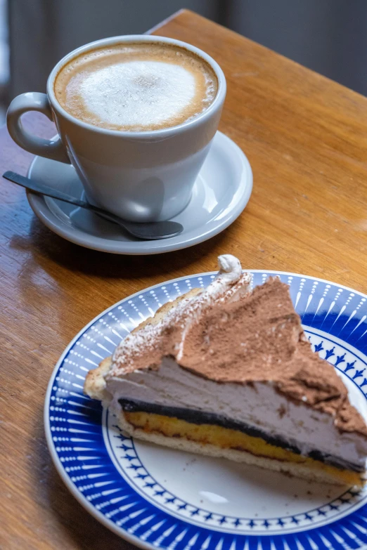 there is a slice of dessert and a cup of coffee