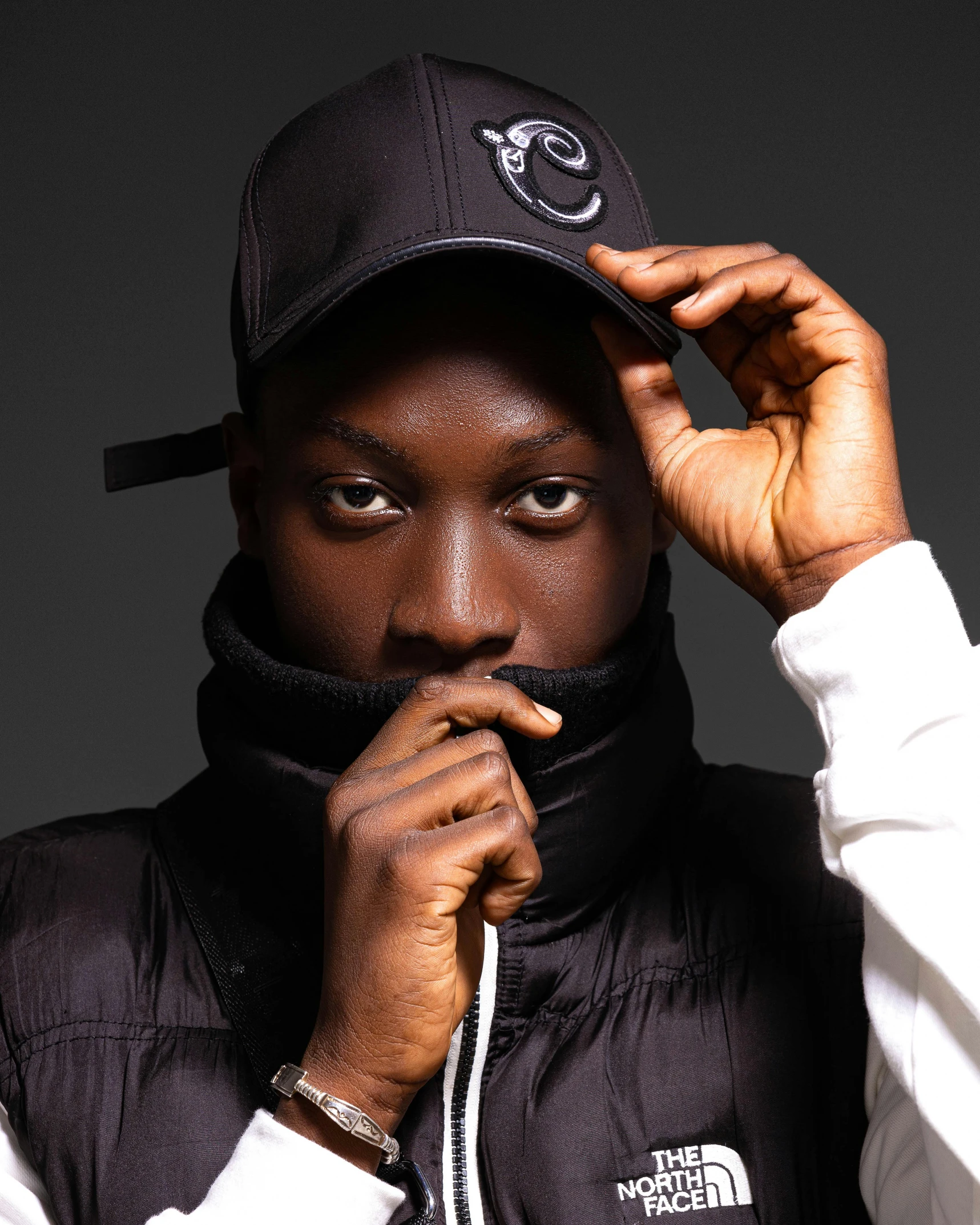 a black man in a cap and scarf