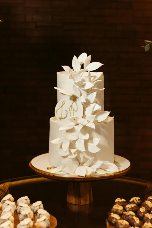 there is a three tiered white cake with flowers on it