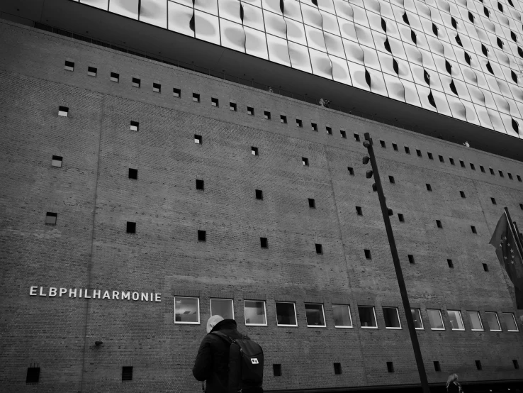 a man is standing on a side walk next to the building