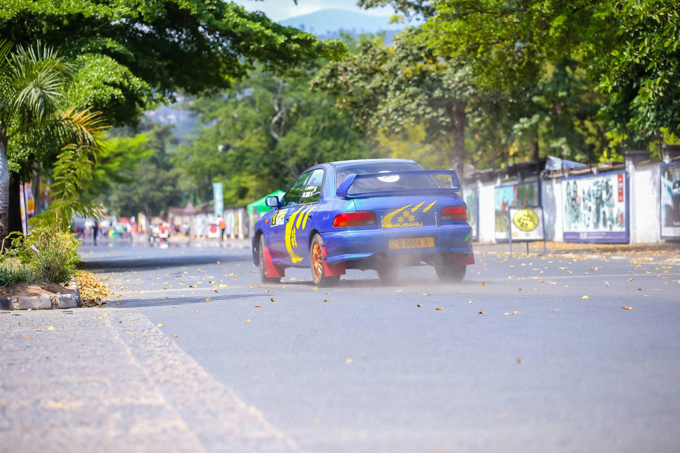 the car is driving down the street during the race