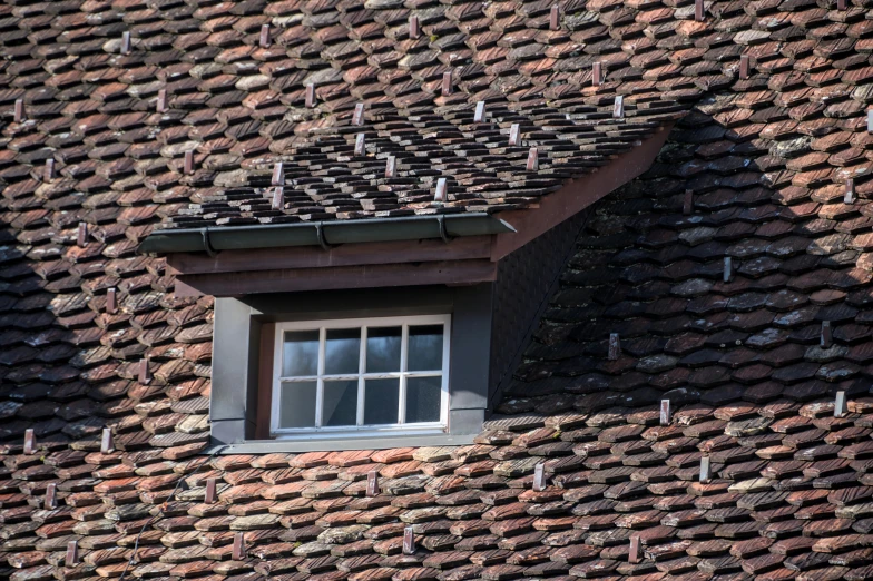 a close - up of a brick roof that has a window on top