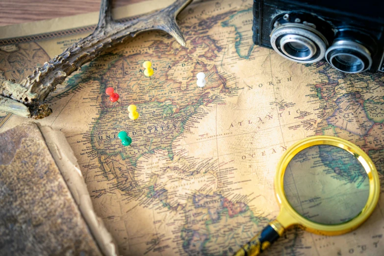 a vintage map and some miniature magnets are on a desk