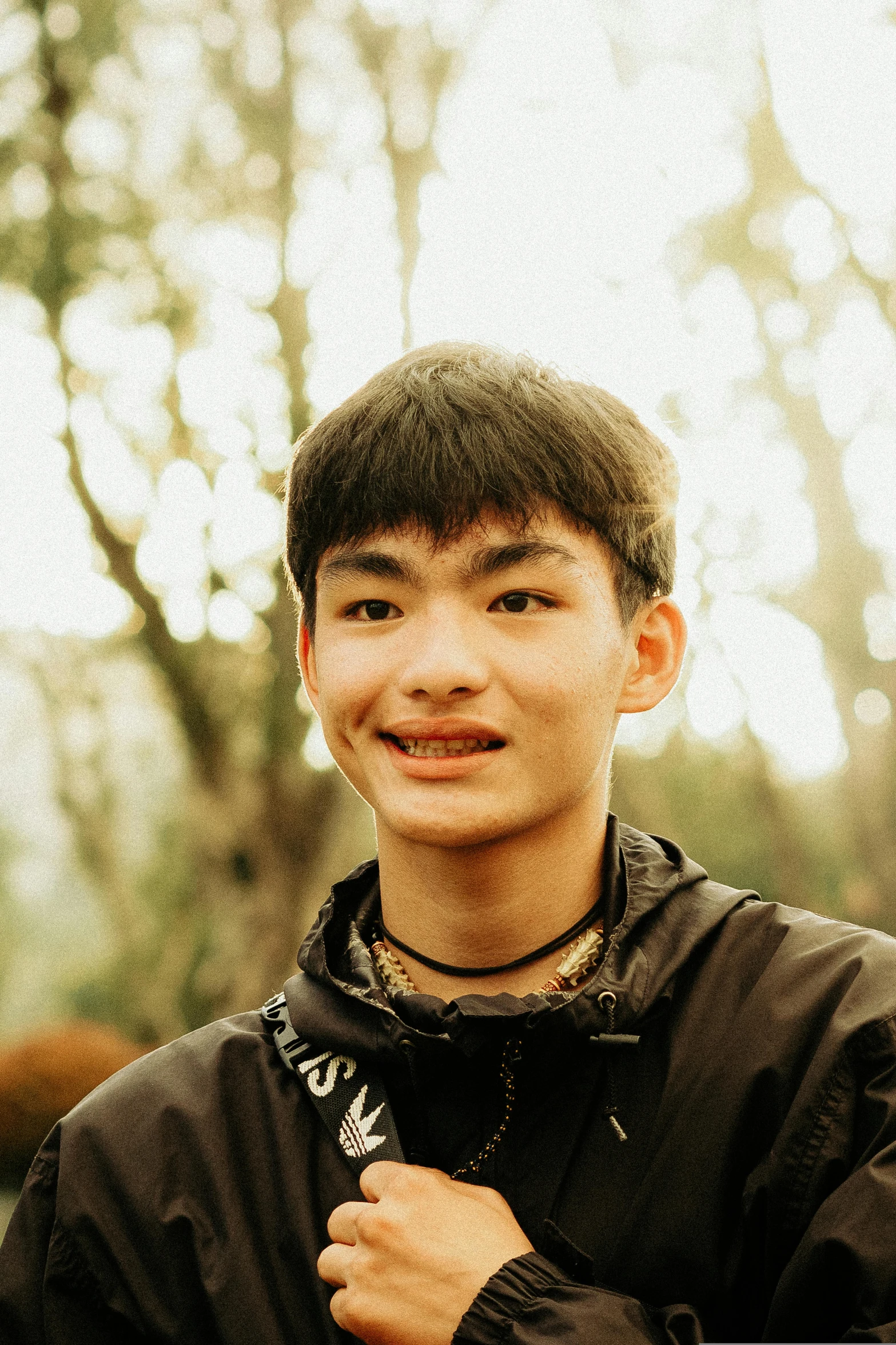 a man standing in the woods wearing a jacket