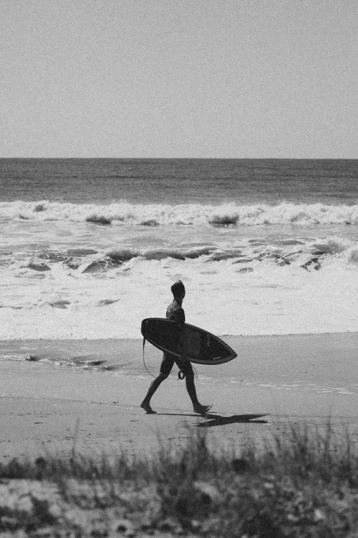 a man with a surfboard is walking by the beach