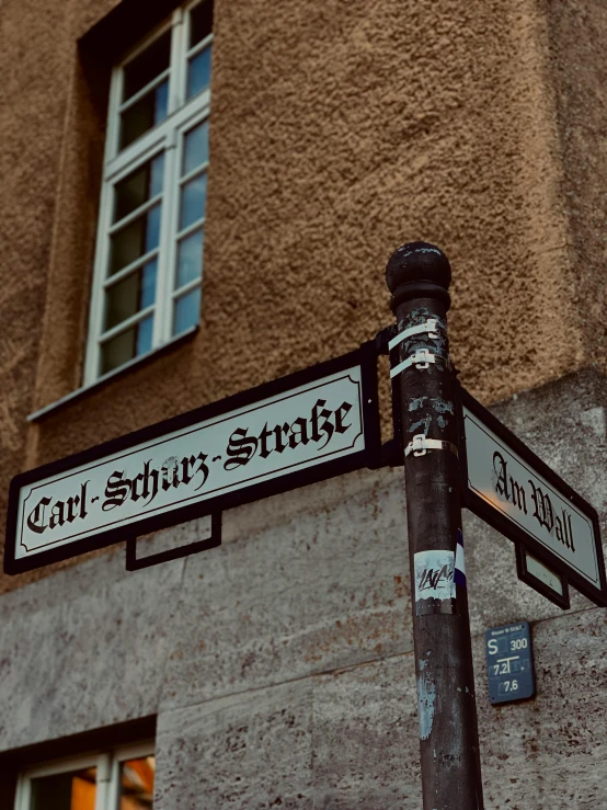 a street sign near a tall brown building