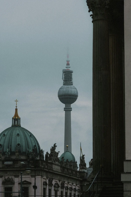 a tall building with a tower next to a large building