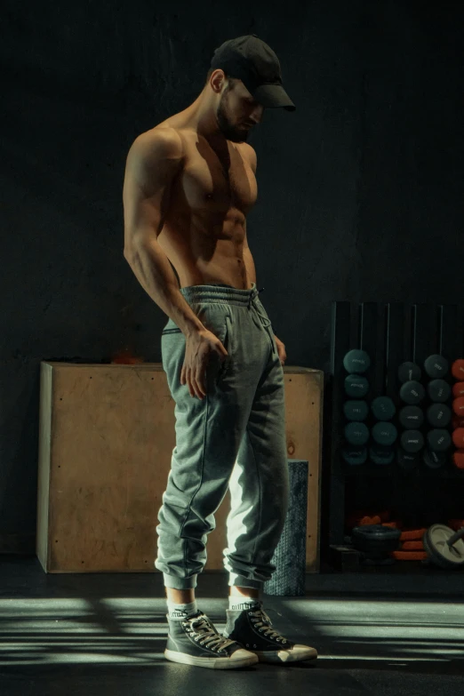 man in gym pants standing and looking down