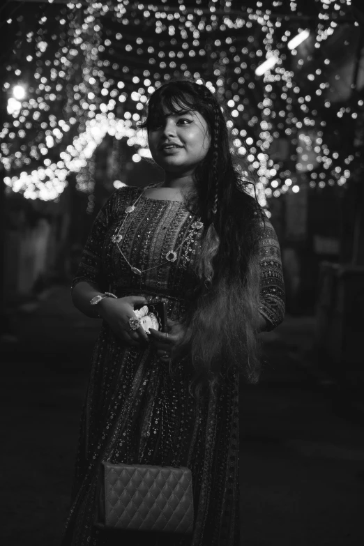 black and white image of woman in front of lights