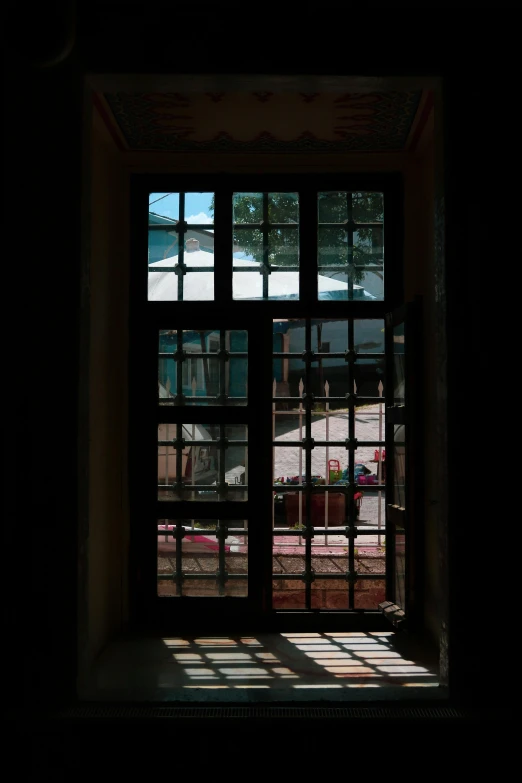 window frames seen in an old building with a man walking by