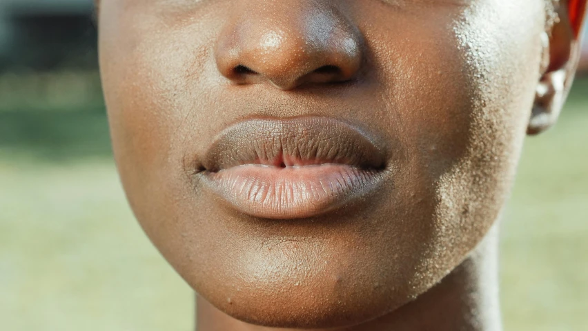 a close up of a person's face with a short orange hair