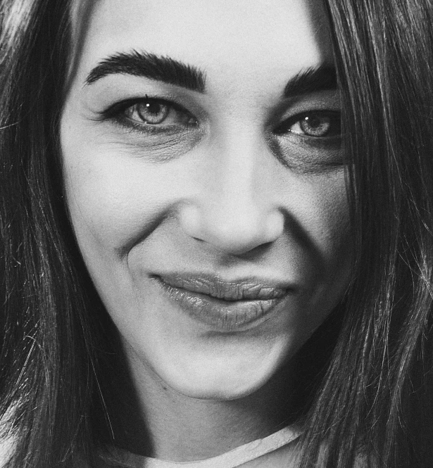 black and white pograph of woman with long hair smiling