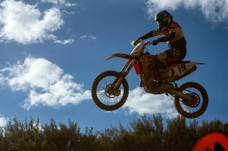 a man doing tricks on his dirt bike