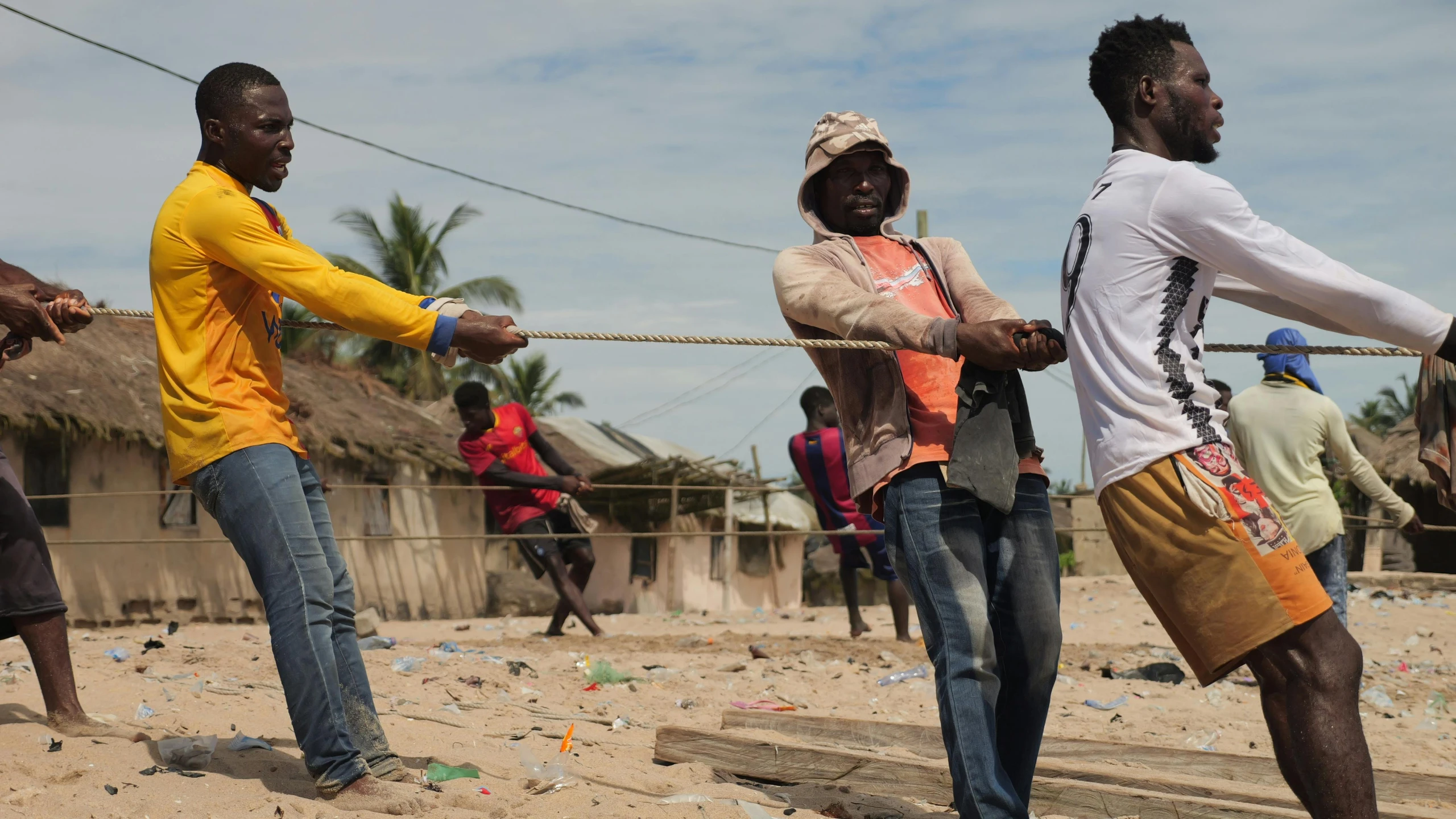 some men are holding on to a rope