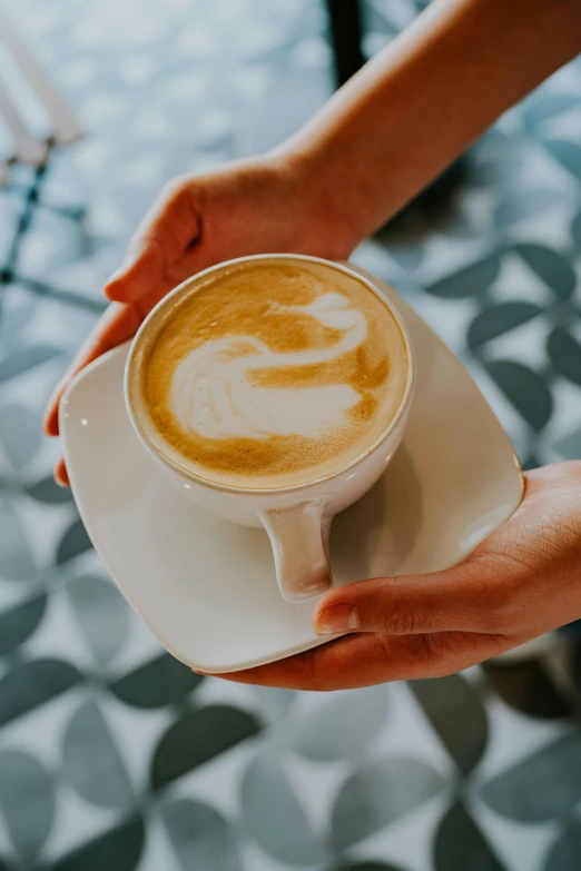 someone holding a cup of coffee in their hand