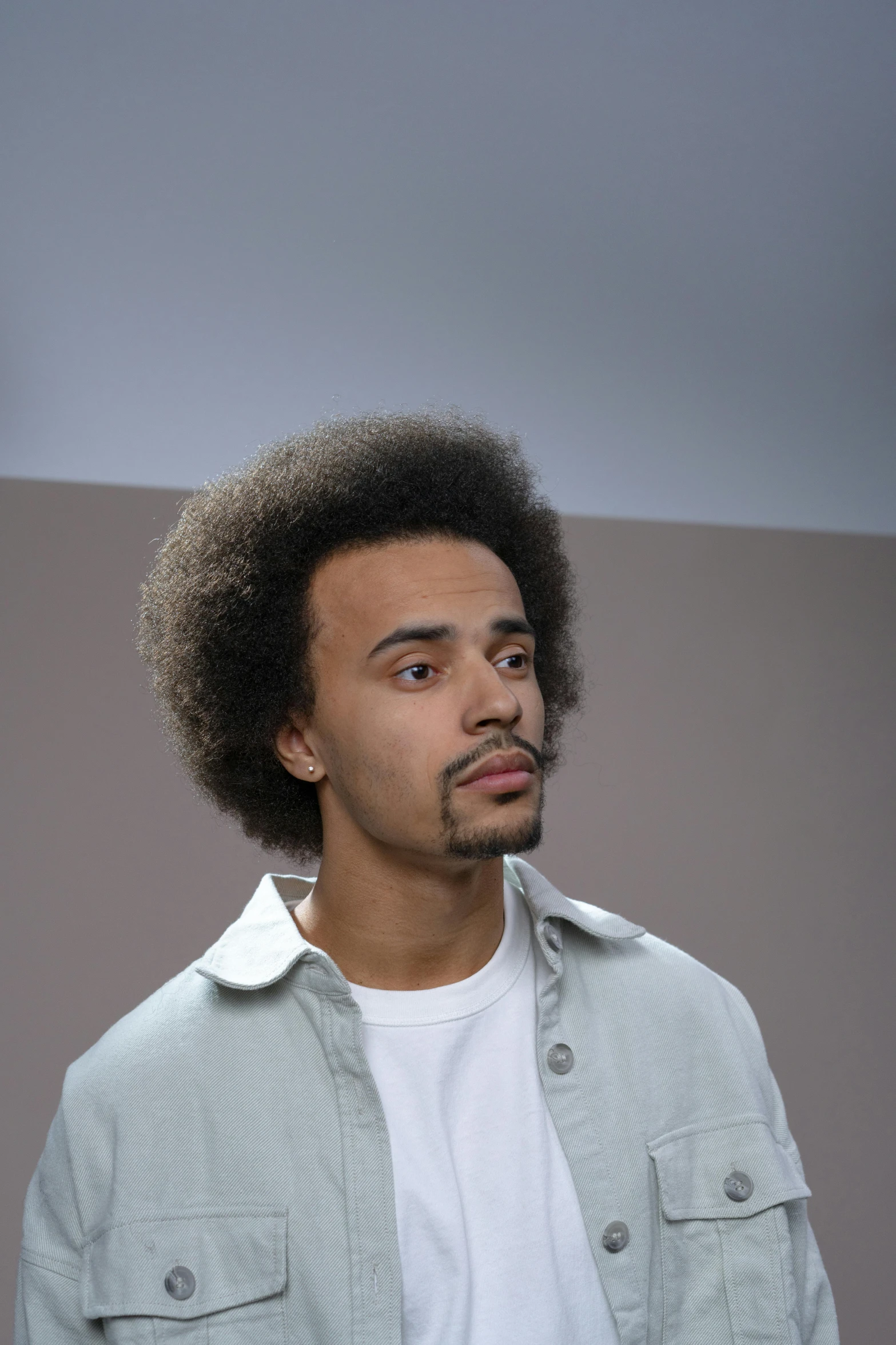 a close up of a person with an afro and shirt