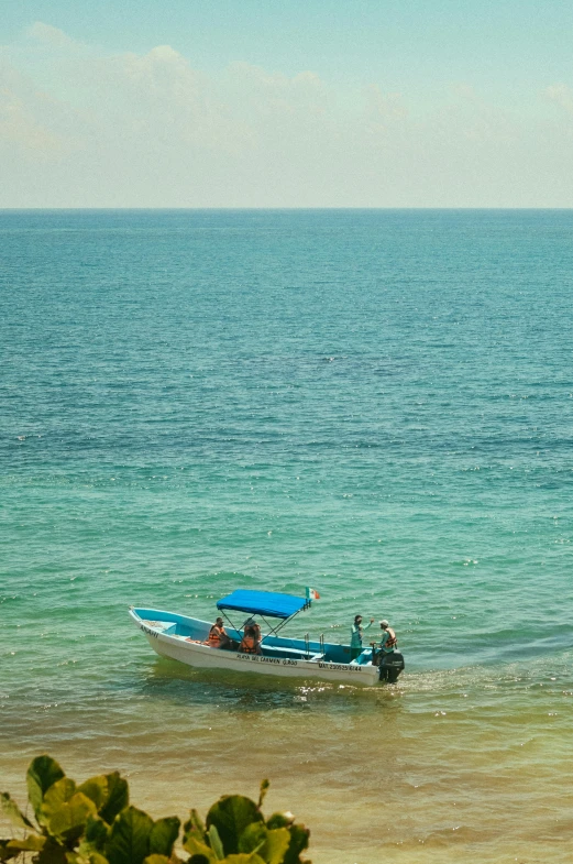 three people on a boat in the water