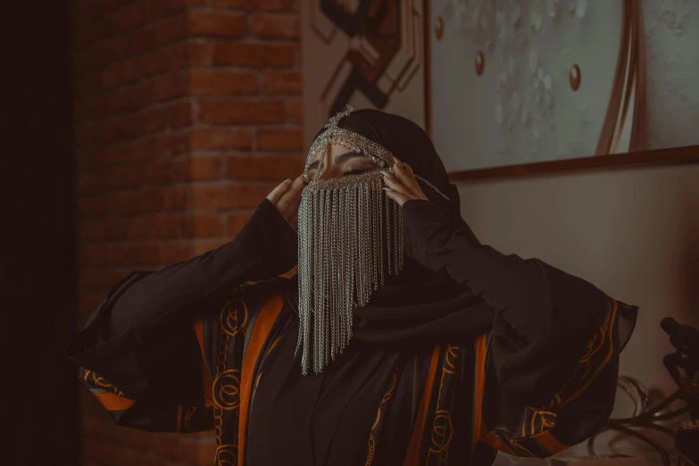 woman wearing pearls and a black outfit in a room