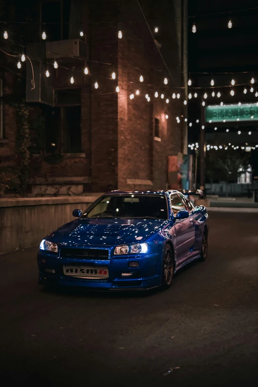 blue convertible parked on the side of the road