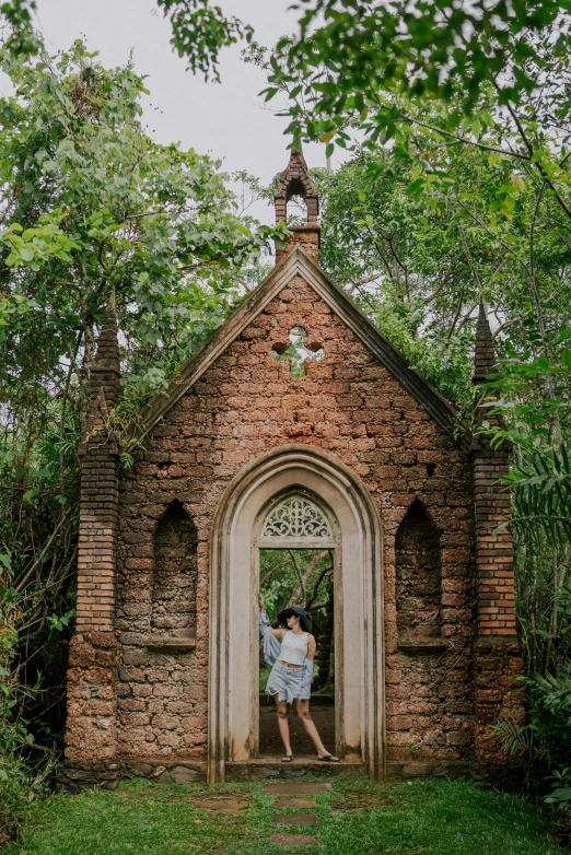 two people are taking pictures of an old brick church