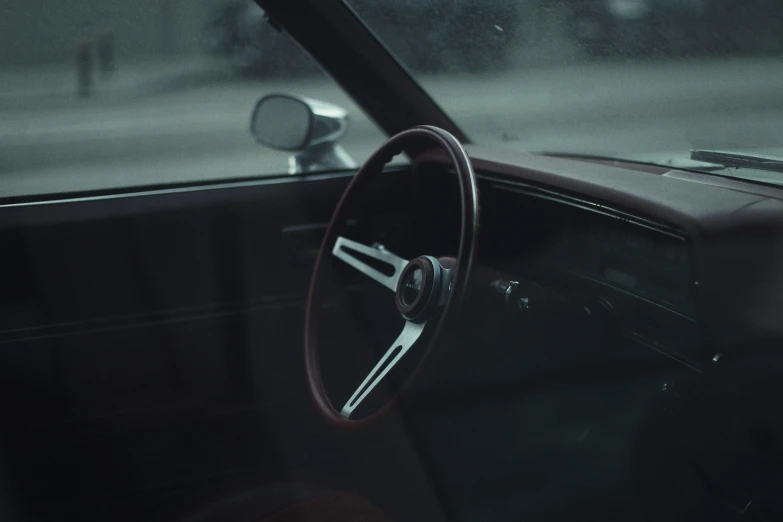 a vintage car dashboard sits in a parking lot