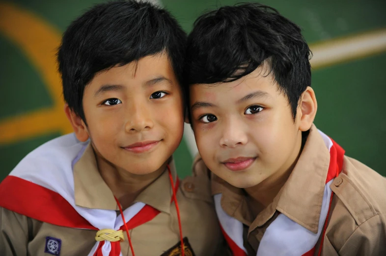 two small boys pose for the camera wearing their scout uniforms