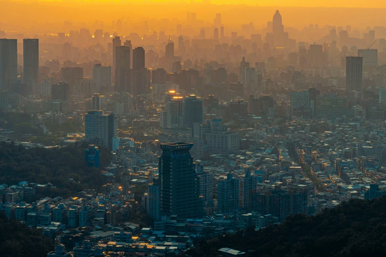 a city skyline with tall buildings lit up at sunset