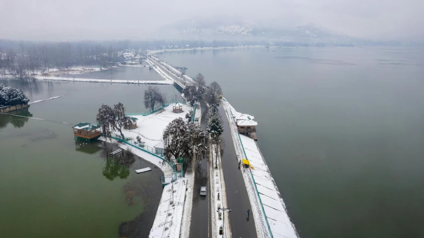 a snow covered bridge stretches into the distance