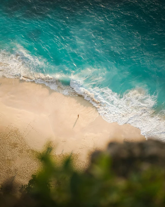 a beach with a surfboard that is next to the ocean