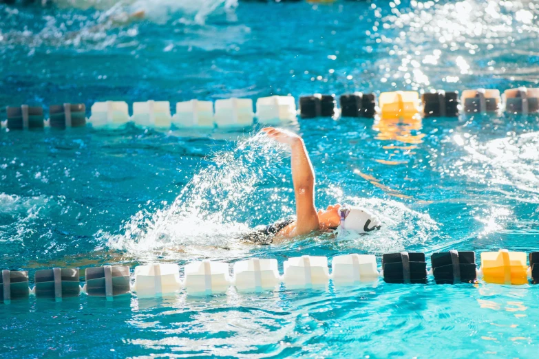 the swimmer is about to race down the pool