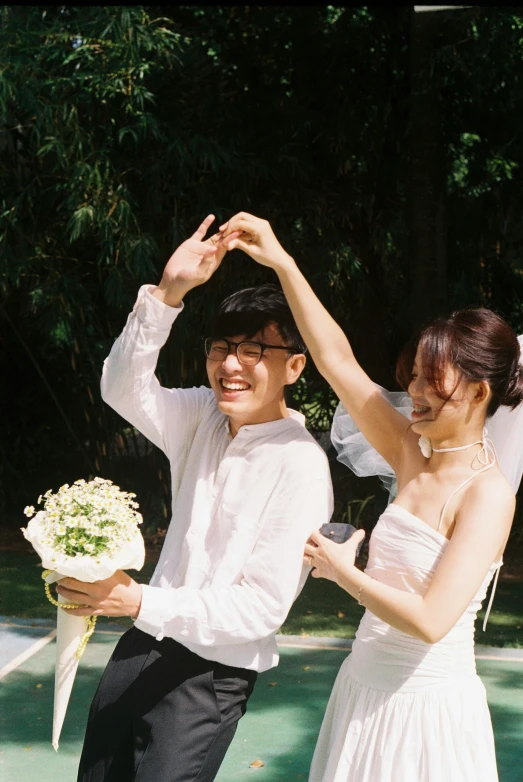 a young couple posing for a pograph on their wedding day