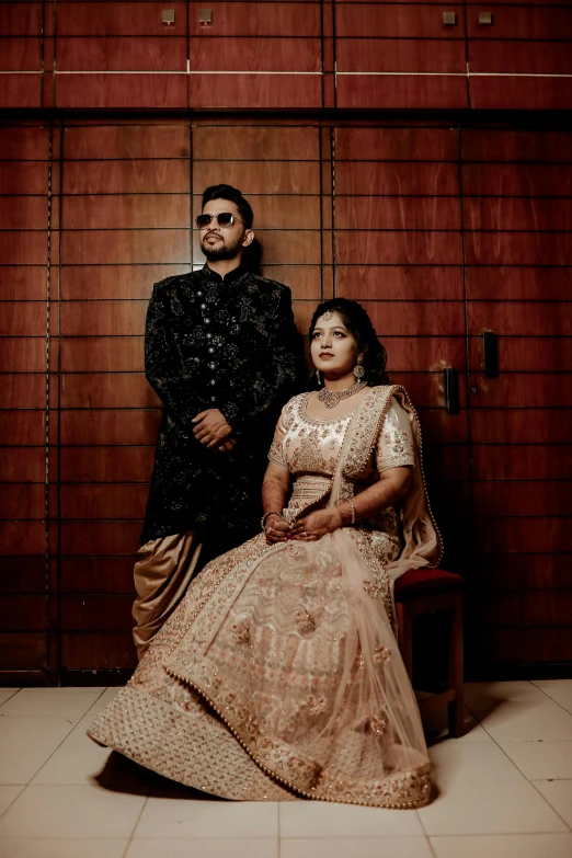 an indian couple standing side by side posing for the camera