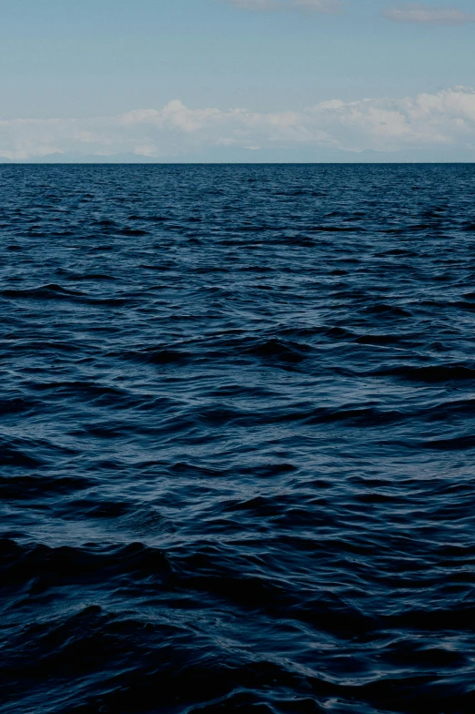 a lone boat in the middle of a body of water