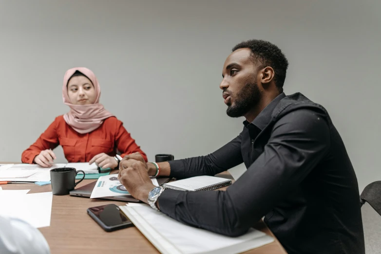 two people are sitting at a table together