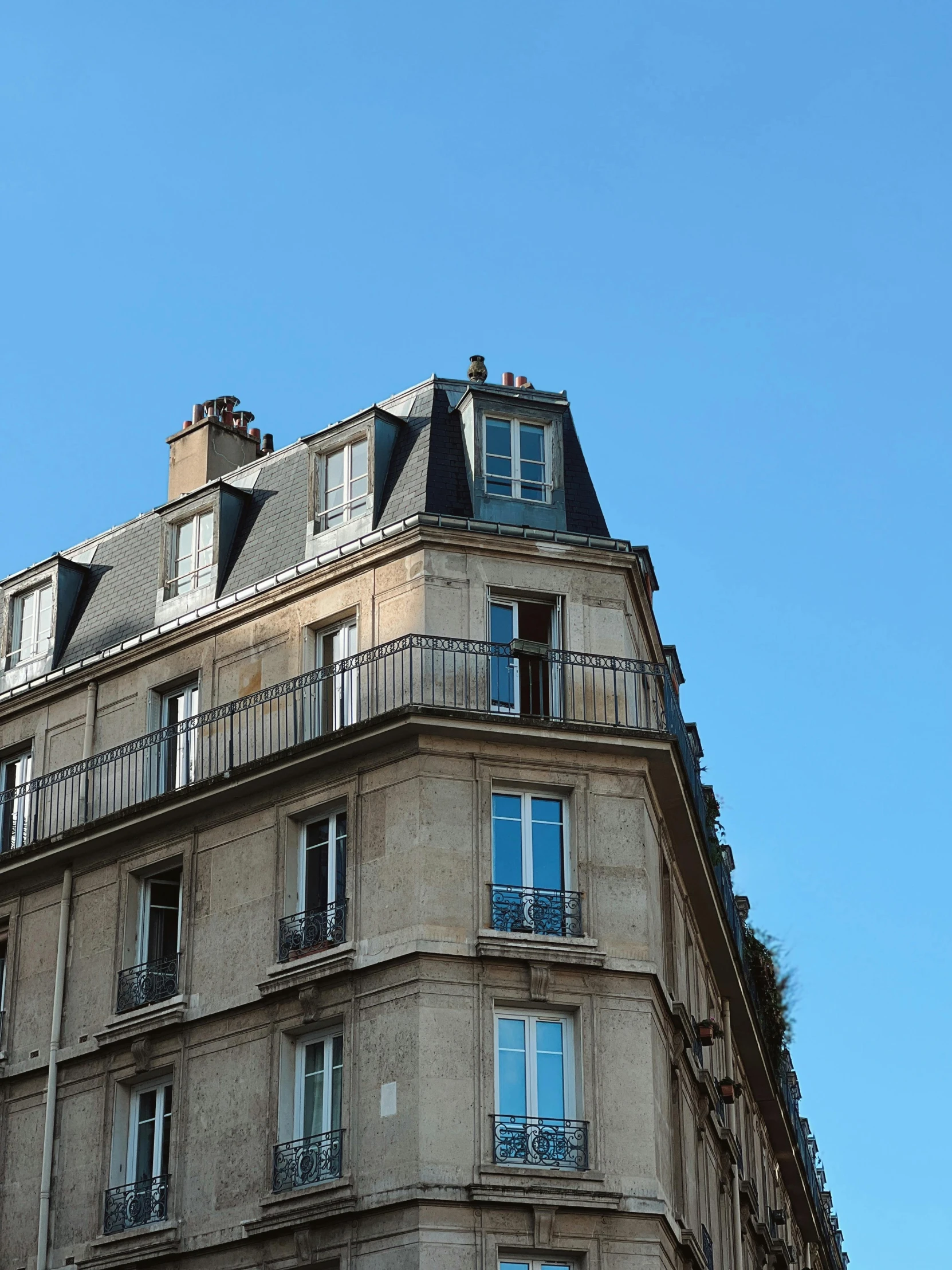 a tall building with balconies near a street sign