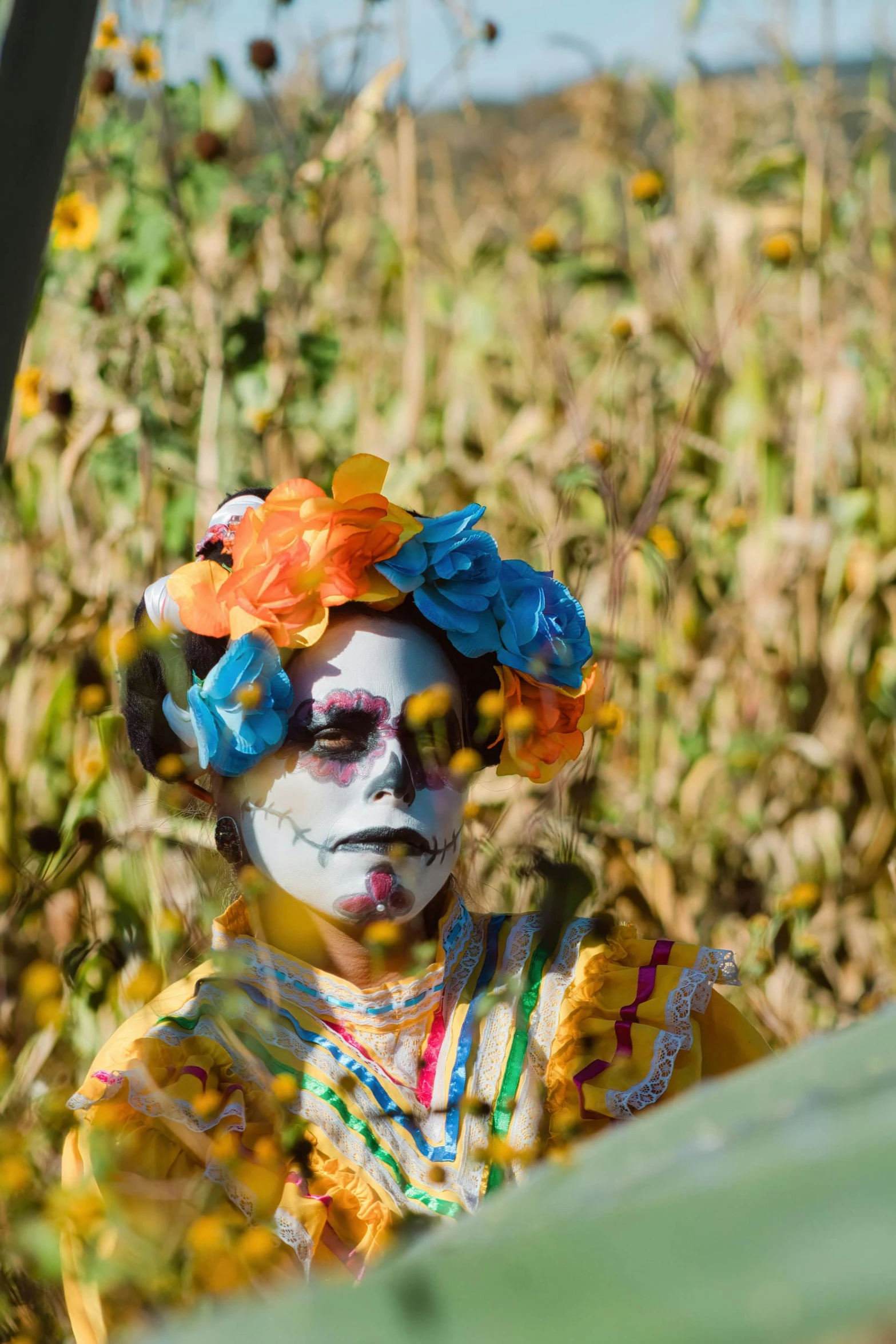 a person with painted face and body on wearing sunflowers