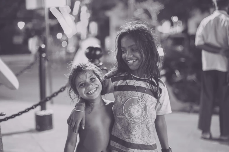 two s laughing on a city sidewalk