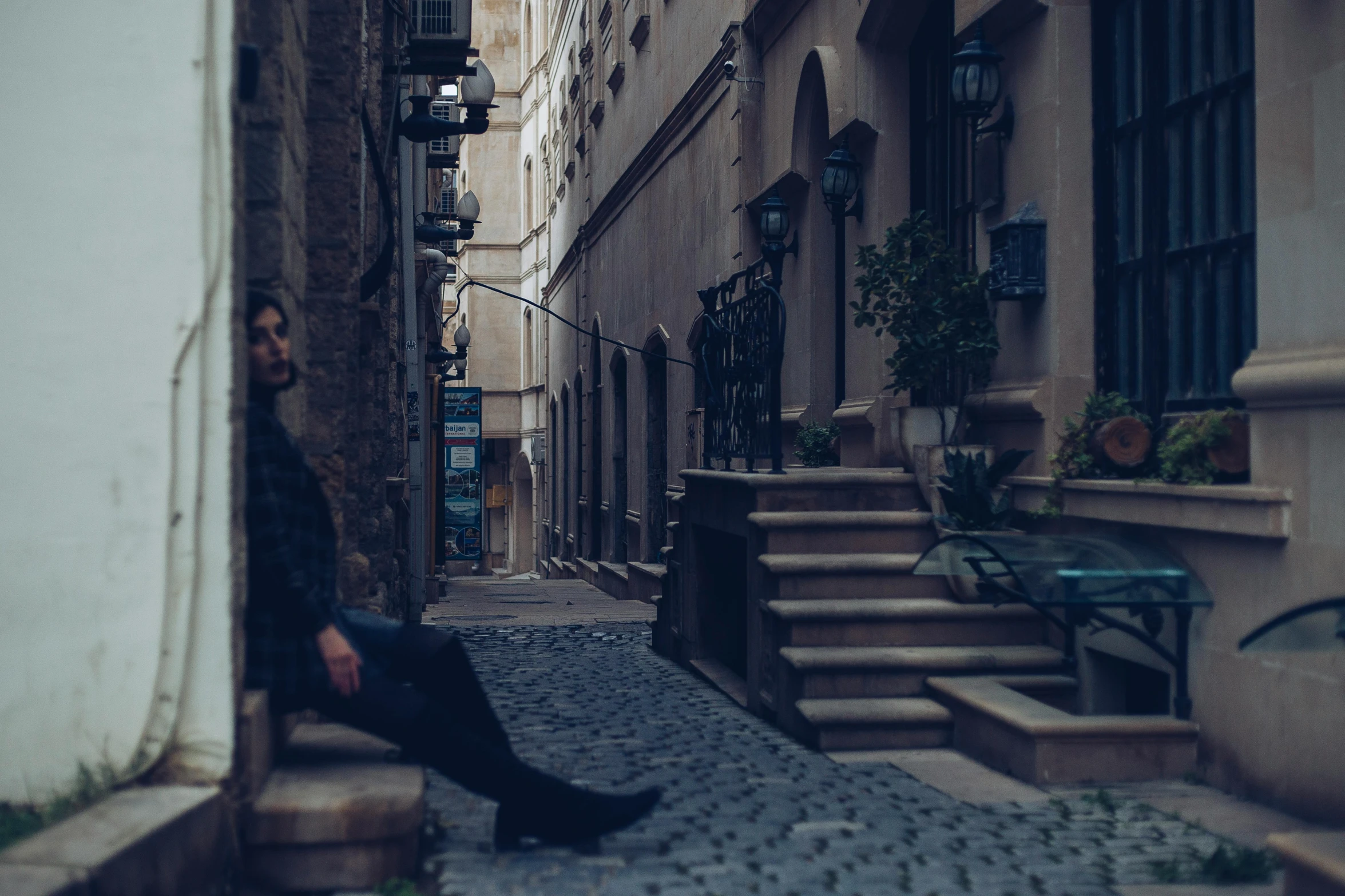 a man is sitting down on some steps in front of a building