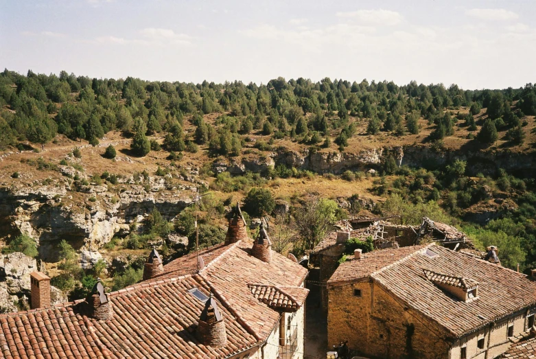 a view of a landscape and some building roofs