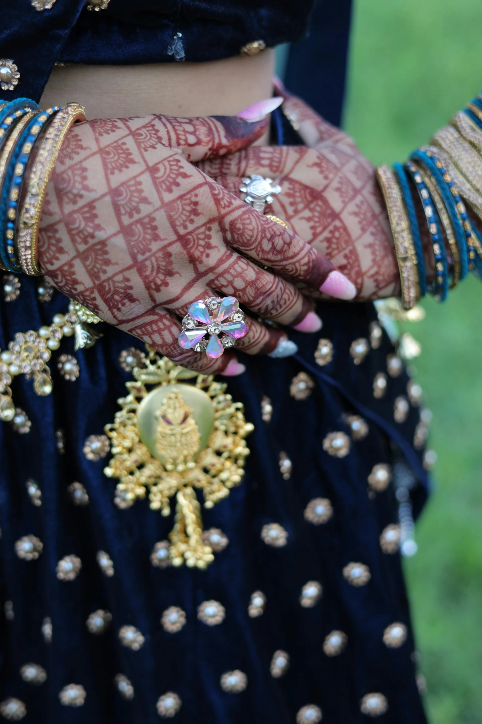 a woman's hands and celets with henches