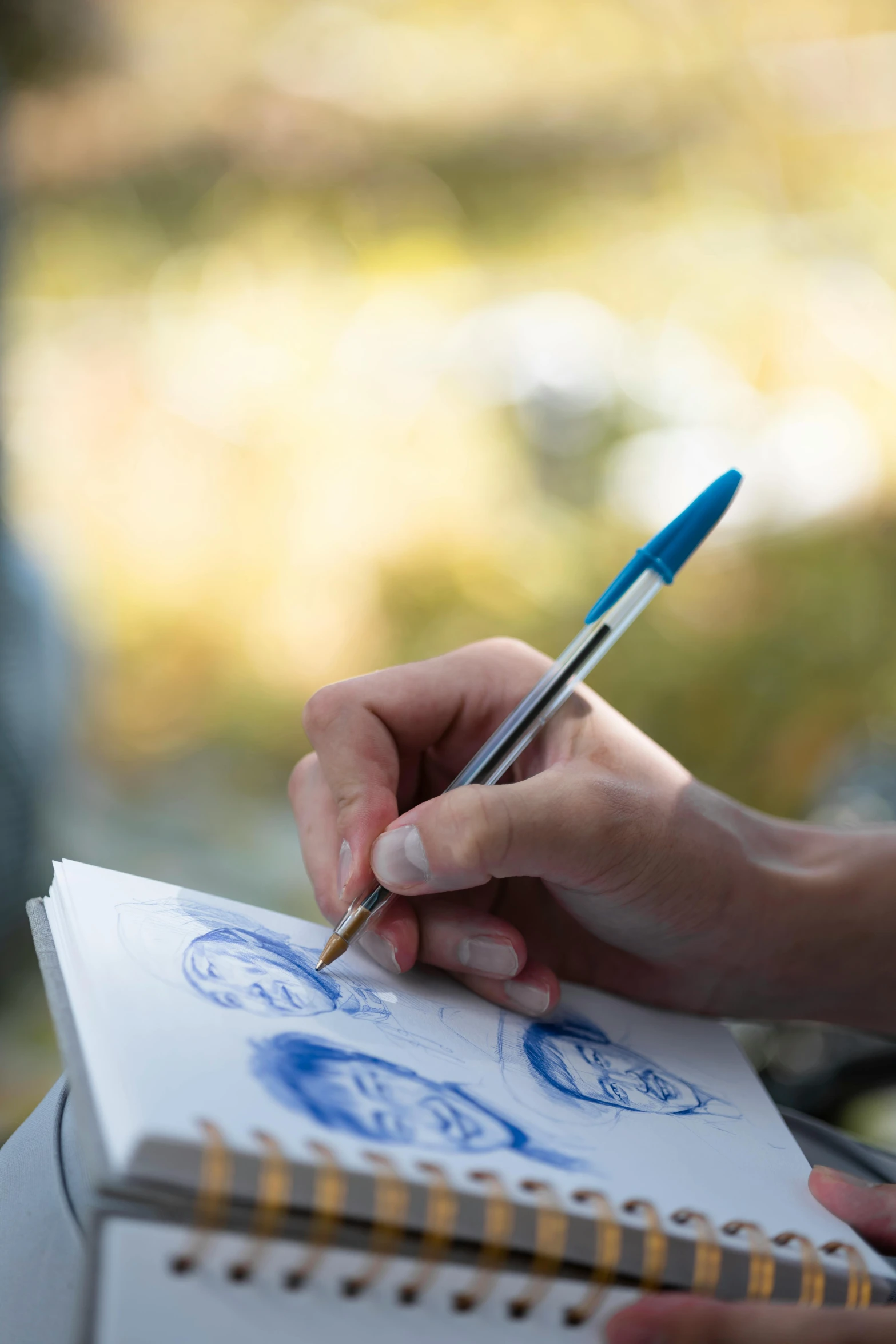 a person is writing on a white sheet and holding a pen