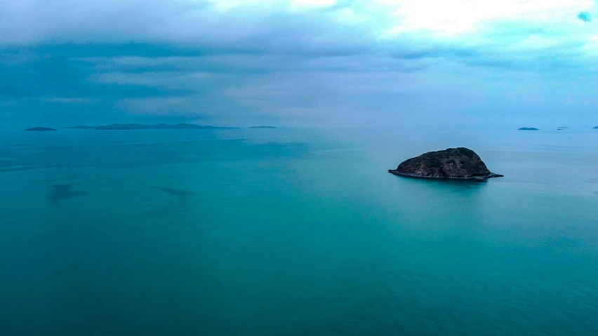 an island in the middle of a vast blue sea