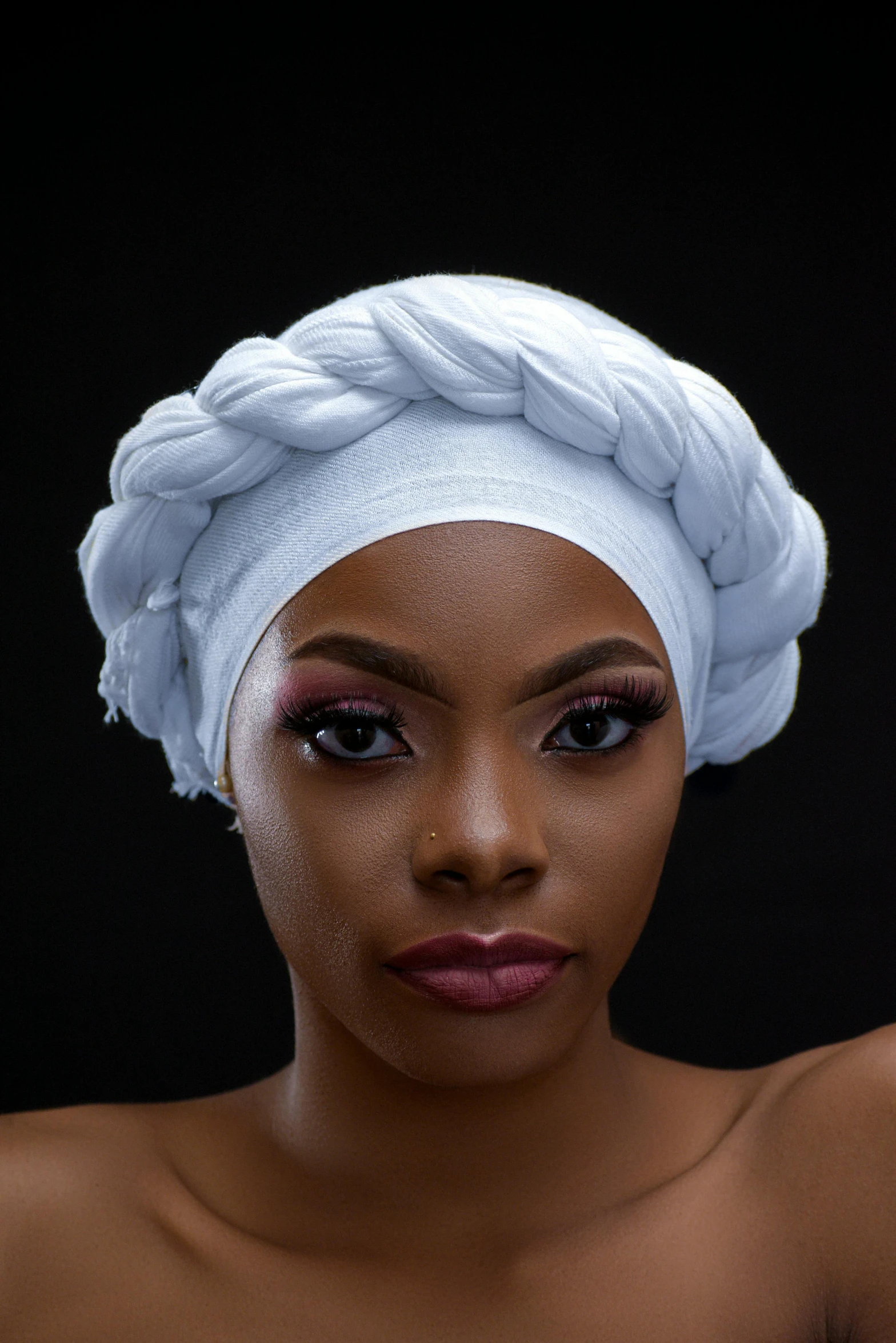 a young black woman with a white towel on her head