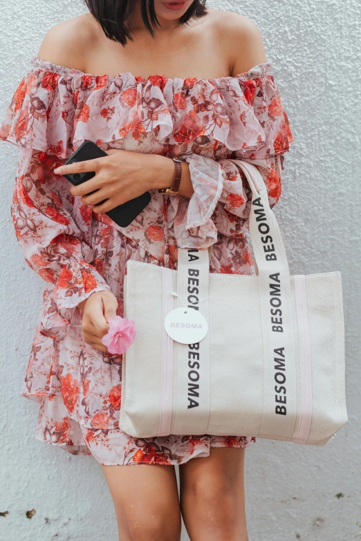 a woman is carrying a bag and wearing it